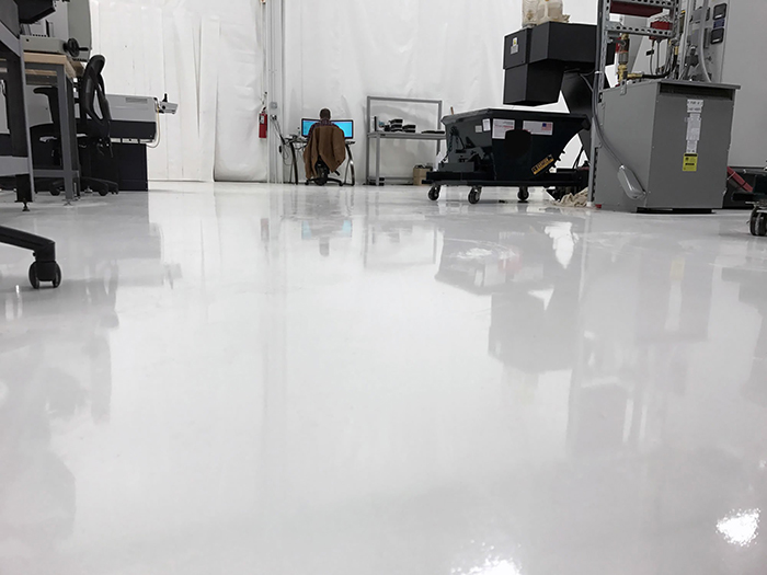 white warehouse floor coating with machines